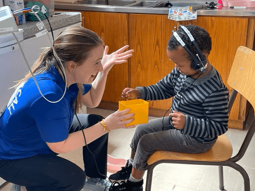 Dr. Cara Donovan providing hearing care on a Hearing the Call humanitarian trip