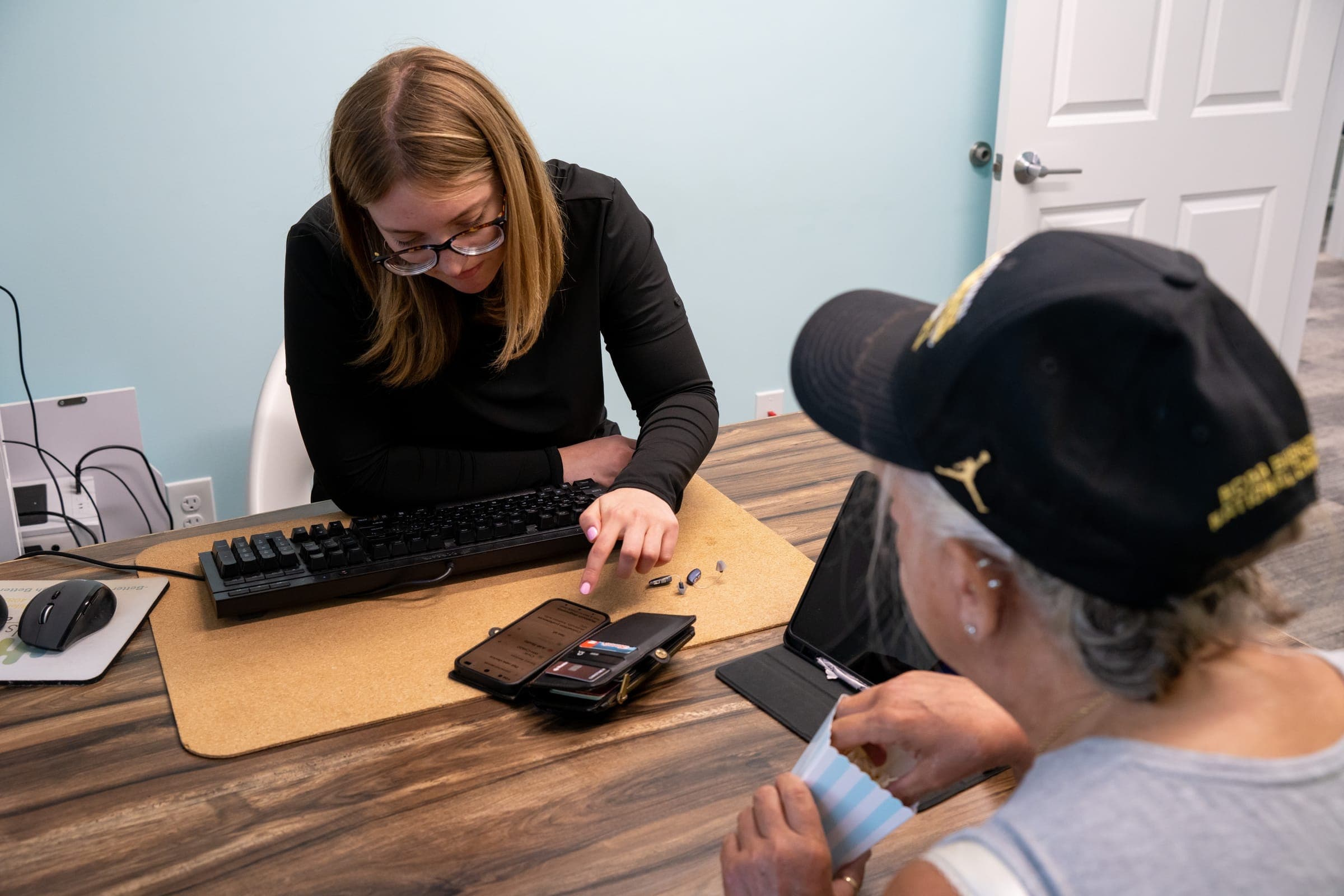 An audiologist reviewing results on screen with a patient at Sounds of Life Hearing Center