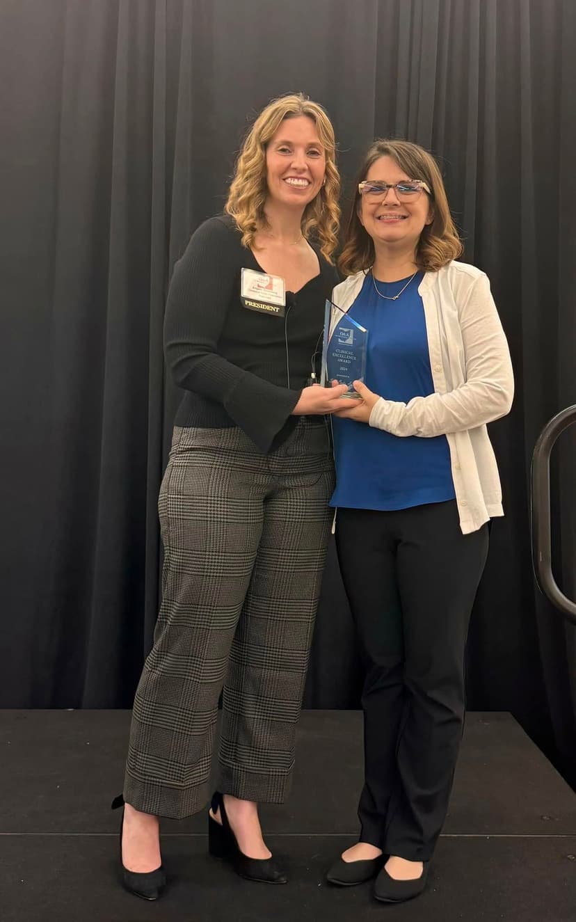 Dr. Sarah Curtis receiving the OAA Clinical Excellence Award for outstanding contributions to audiology